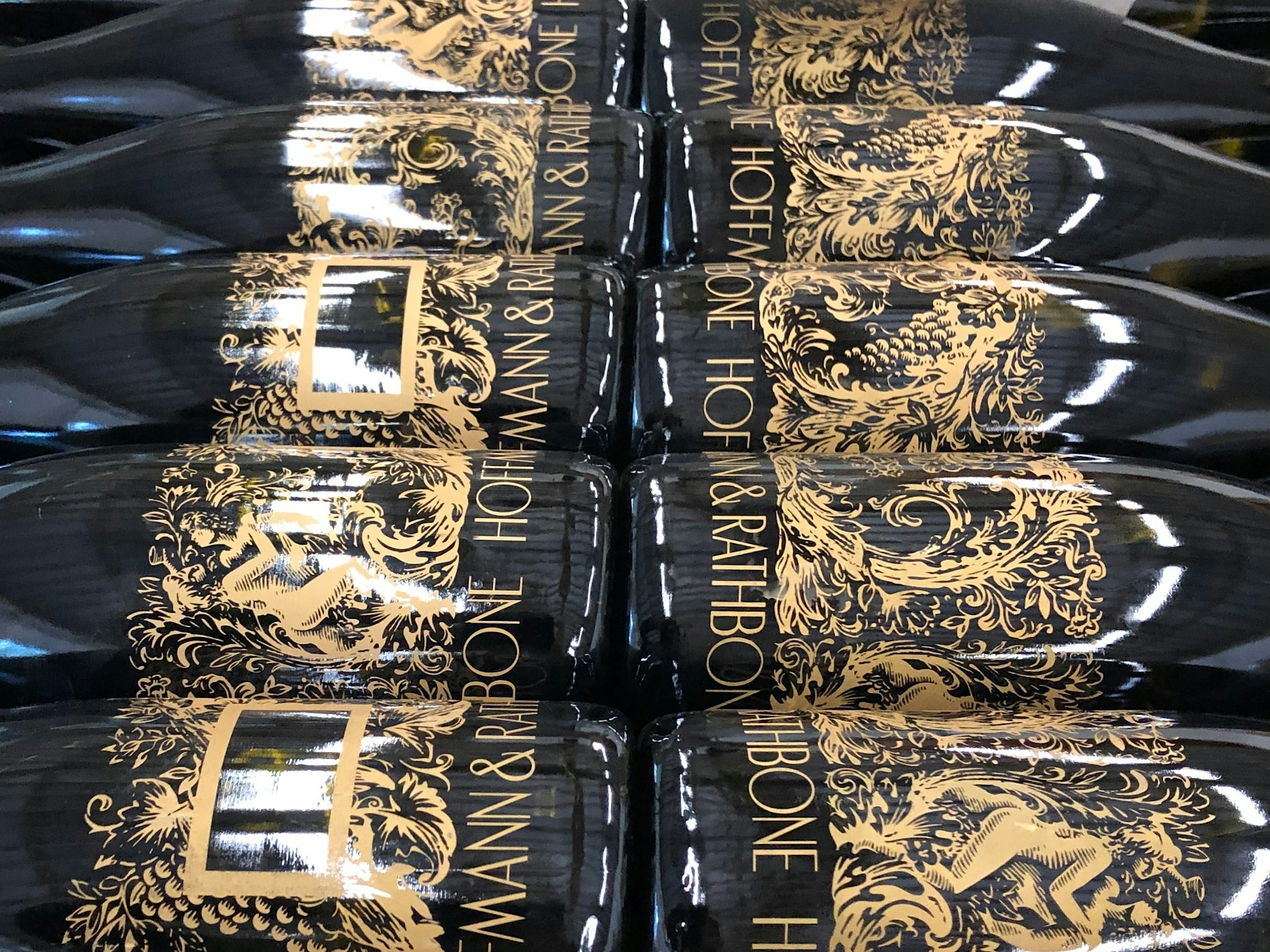 Hoffmann & Rathbone wine bottles stacked ready for labelling.